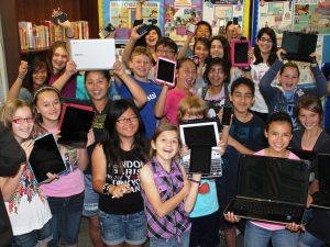 kids holding up digital devices