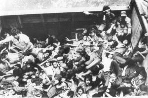 Many distressed people tightly crammed onto a boat