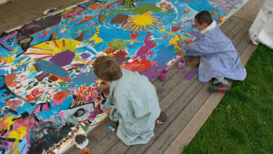 Children painting a colourful mural