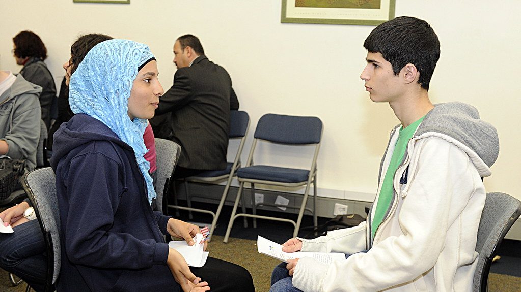 Teenage girl and boy having a serious discussion