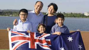 Family holding Australian flag on Citizenship Day