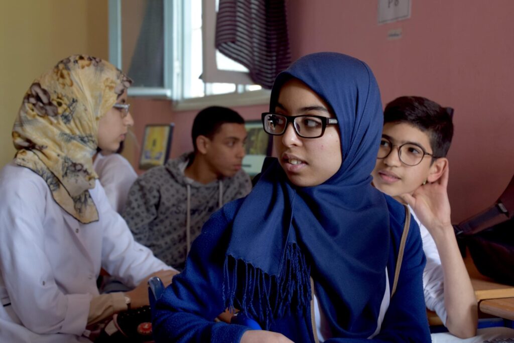 Female student raising her hand to ask a question