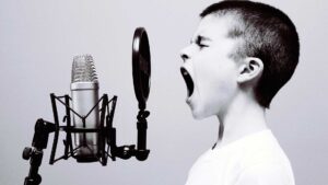 Boy yelling into microphone