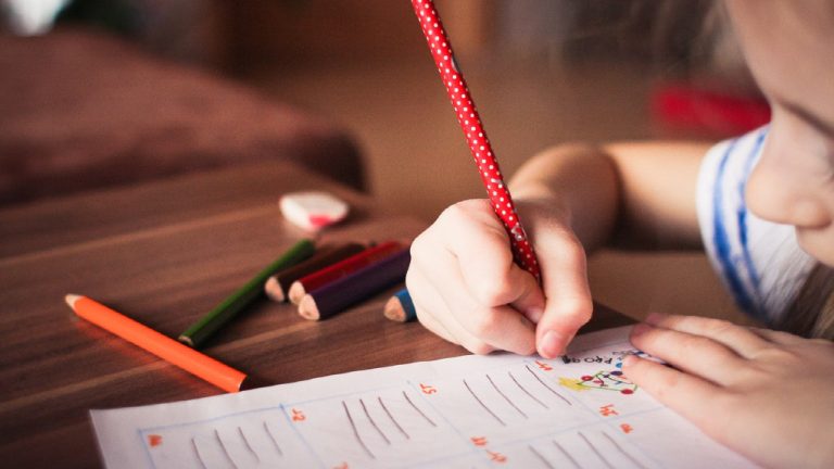 Close up of girl writing